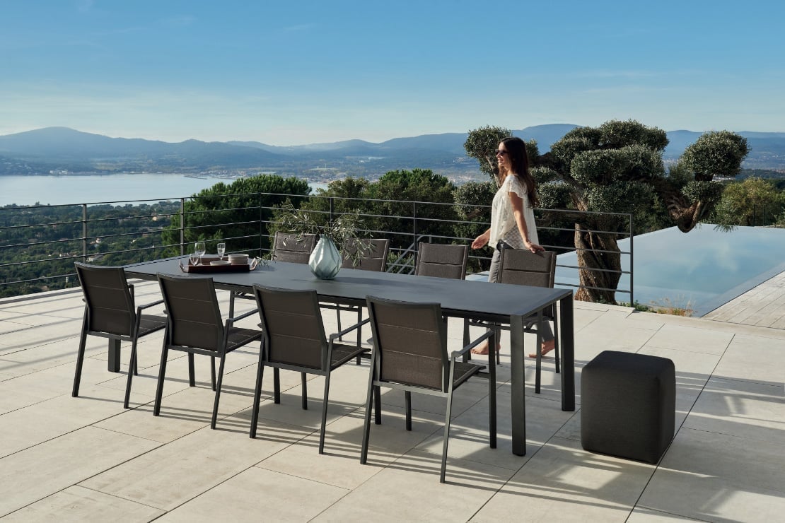 Moderner Gartentisch mit acht Stühlen auf Terrasse.